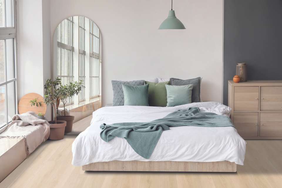 serene colour palette in modern minimal bedroom with light oak wood floors and arched mirror